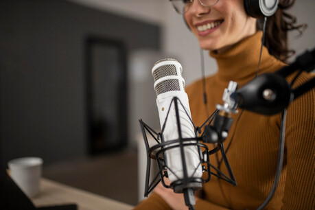 woman-broadcasting-on-radio-while-smiling.jpg